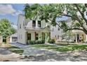 Elegant two-story home showcasing clean lines, a modern design, and lush landscaping with a classic tree at 833 Dartmouth St, Orlando, FL 32804