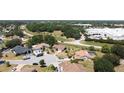 Aerial view of homes in a residential area with mature trees and landscaping at 857 E Flag Ln, Kissimmee, FL 34759