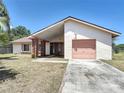 Charming single-story home featuring desert landscaping and a single-car garage at 857 E Flag Ln, Kissimmee, FL 34759
