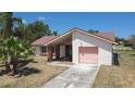 Charming one-story home featuring a single-car garage and neutral exterior paint at 857 E Flag Ln, Kissimmee, FL 34759