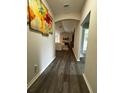 Hallway with dark wood floors leading to an open concept living area with modern decor at 9028 Se 41St Court Rd, Ocala, FL 34480