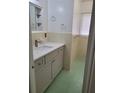 Well-lit bathroom featuring a modern vanity, updated fixtures, and retro tiled walls at 936 Pinedale Ave, Orlando, FL 32808