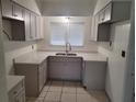 Updated kitchen featuring sleek countertops, ample cabinet space, and modern stainless steel fixtures at 936 Pinedale Ave, Orlando, FL 32808
