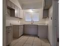 A renovated kitchen featuring modern cabinetry, updated countertops, and a stainless steel faucet at 936 Pinedale Ave, Orlando, FL 32808