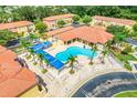 Aerial view showcasing the community pool with cabanas, lounge chairs, and lush landscaping at 1000 Park Club Dr, Kissimmee, FL 34746