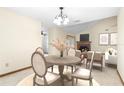 Cozy dining area featuring a round table, four chairs, and a view of a fireplace and living space at 1003 Chesterfield Cir, Winter Springs, FL 32708