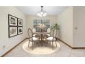 Elegant dining area features a round table, four chairs, natural light, and classic decor elements at 1003 Chesterfield Cir, Winter Springs, FL 32708