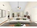 Bright living room featuring a modern sofa, high ceilings, and neutral decor, creating an inviting atmosphere at 1003 Chesterfield Cir, Winter Springs, FL 32708
