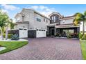 Stately two-story home featuring a three-car garage and paved driveway with beautiful landscaping at 10196 Bucklow Hill Dr, Orlando, FL 32832