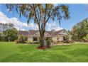 Well-maintained home with lush lawn, mature trees, and attractive landscaping at 10528 Old Dade City Rd, Lakeland, FL 33810