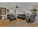 Comfortable living room with leather furniture, ceiling fan, and tile flooring at 10528 Old Dade City Rd, Lakeland, FL 33810