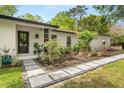 Inviting front entrance with stone walkway and lush landscaping leading to the front door at 1113 Black Acre Trl, Winter Springs, FL 32708