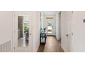 Inviting hallway with hardwood floors and access to the kitchen, entry door and other rooms at 1196 Alstonia Ln, Mount Dora, FL 32757