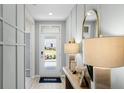 Inviting entryway with wood-look flooring, decorative molding, and a front door leading to a landscaped yard at 1200 Alstonia Ln, Mount Dora, FL 32757