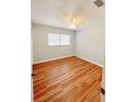 Cozy bedroom with wood floors, natural light, and a ceiling fan at 1603 Gaston Foster Rd, Orlando, FL 32812