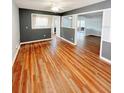 Bright and airy living room featuring hardwood floors, neutral paint, and open access to the kitchen at 1603 Gaston Foster Rd, Orlando, FL 32812