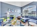 Cozy living room with large arched window, comfortable seating, and stylish decor at 1610 River Birch Ave, Oviedo, FL 32765
