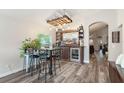 Stylish living room featuring a home bar area with custom wooden bar and shelving, seating, and modern flooring at 2098 Carpathian Dr, Apopka, FL 32712
