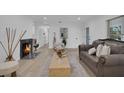 Bright living room with a fireplace, hardwood floors, and ample seating at 245 W George Ave, Maitland, FL 32751