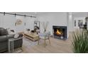 Cozy living room featuring a fireplace, hardwood floors, and modern decor at 245 W George Ave, Maitland, FL 32751