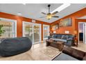 Inviting living room with skylights, ceiling fan, tile floors and sliding glass doors to the exterior at 2665 E Juliet Dr, Deltona, FL 32738