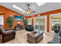 Open living room featuring skylights, ceiling fan, tile floors, and a cozy entertainment center at 2665 E Juliet Dr, Deltona, FL 32738
