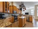 Well-equipped kitchen with custom cabinets, granite countertops, stainless steel appliances, and central island at 27127 Stoney Brook Dr, Leesburg, FL 34748