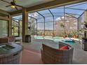 Relaxing screened-in lanai with an outdoor living space and a private pool surrounded by lush plants at 27127 Stoney Brook Dr, Leesburg, FL 34748