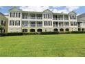 Charming condo building with multiple balconies overlooking a lush green lawn at 280 Celebration Blvd # 208, Kissimmee, FL 34747