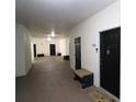 Hallway features multiple unit doors with seating and textured flooring at 280 Celebration Blvd # 208, Kissimmee, FL 34747