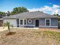 Charming one-story home with a decorative circular window and an attached one car garage at 2818 Irondale St, Deltona, FL 32738