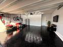 Well-organized garage with epoxy floors, overhead lighting, and plenty of storage space at 321 Jovana Rd, Davenport, FL 33837