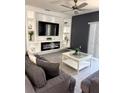 Inviting living room features a modern fireplace, stylish decor and a ceiling fan at 321 Jovana Rd, Davenport, FL 33837