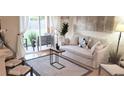 Bright living room with sliding glass doors leading to a patio, complemented by stylish furniture and decor at 416 Calabria Ave, Davenport, FL 33897