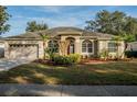 Attractive single-story house with a manicured lawn and mature landscaping at 4837 Lorraine Way, Orlando, FL 32812