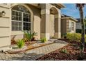 Close up of a well landscaped front yard with brick pavers leading to the front door at 4837 Lorraine Way, Orlando, FL 32812