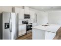 Modern kitchen featuring stainless steel appliances, island, white cabinetry and stylish countertops at 5258 Scrub Mint, Apopka, FL 32712