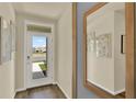 Inviting entryway featuring a white front door with glass and neutral walls with art at 5290 Scrub Mint Ln, Apopka, FL 32712