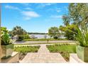 Beautifully landscaped view to the water, showcasing lush greenery and a serene setting at 705 N Lake Sybelia Dr, Maitland, FL 32751