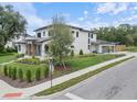 Striking home exterior with lush lawn, complemented by a detached garage and mature landscaping at 705 N Lake Sybelia Dr, Maitland, FL 32751