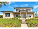 Stunning modern home featuring a clean facade, manicured lawn, and stone walkway at 705 N Lake Sybelia Dr, Maitland, FL 32751
