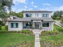 Stunning two-story home with a beautifully landscaped front yard and modern architectural details at 705 N Lake Sybelia Dr, Maitland, FL 32751