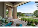 Inviting covered front porch with views of the lake and dock, perfect for relaxing outdoors at 705 N Lake Sybelia Dr, Maitland, FL 32751