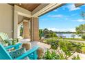 Inviting covered front porch with comfortable seating and scenic lake views at 705 N Lake Sybelia Dr, Maitland, FL 32751