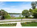 Picturesque lake view from the property, featuring a private dock and lush landscaping at 705 N Lake Sybelia Dr, Maitland, FL 32751