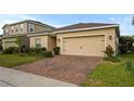 Attractive single-story home with a brick paved driveway and well-maintained landscaping at 714 Golden Elm Dr, Apopka, FL 32703