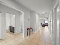 Bright hallway with tile floors, leading to bathroom and living area at 714 Golden Elm Dr, Apopka, FL 32703