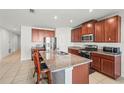 Spacious kitchen with granite countertops, stainless appliances, and a center island at 714 Golden Elm Dr, Apopka, FL 32703