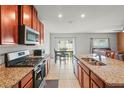 Well-equipped kitchen features granite countertops and stainless steel appliances at 714 Golden Elm Dr, Apopka, FL 32703