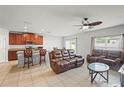 Open-concept living room area boasts tile floors and ample natural light at 714 Golden Elm Dr, Apopka, FL 32703